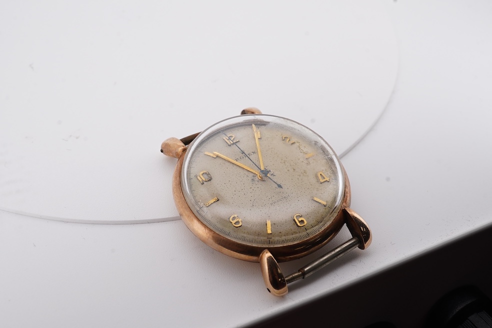 A gentleman's 1940's? 9ct gold Rolex manual wind wrist watch, with signed Super Balance movement, the inner case back numbered 4411 over 844, case diameter 34mm, no strap or winding crown. Condition - poor